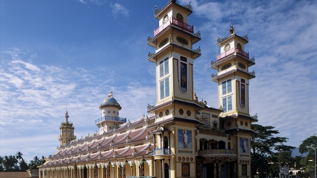 Vietnam, Tay Ninh, Cao Dai Holy See, (Great Divine Temple) with pair towers and blue sky above