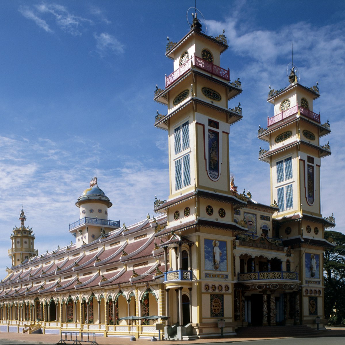 Vietnam, Tay Ninh, Cao Dai Holy See, (Great Divine Temple) with pair towers and blue sky above