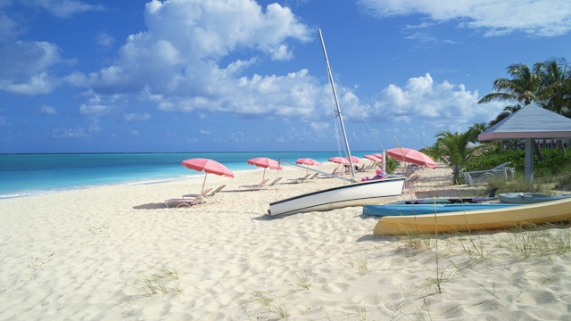 Beach with umbrellas and boats