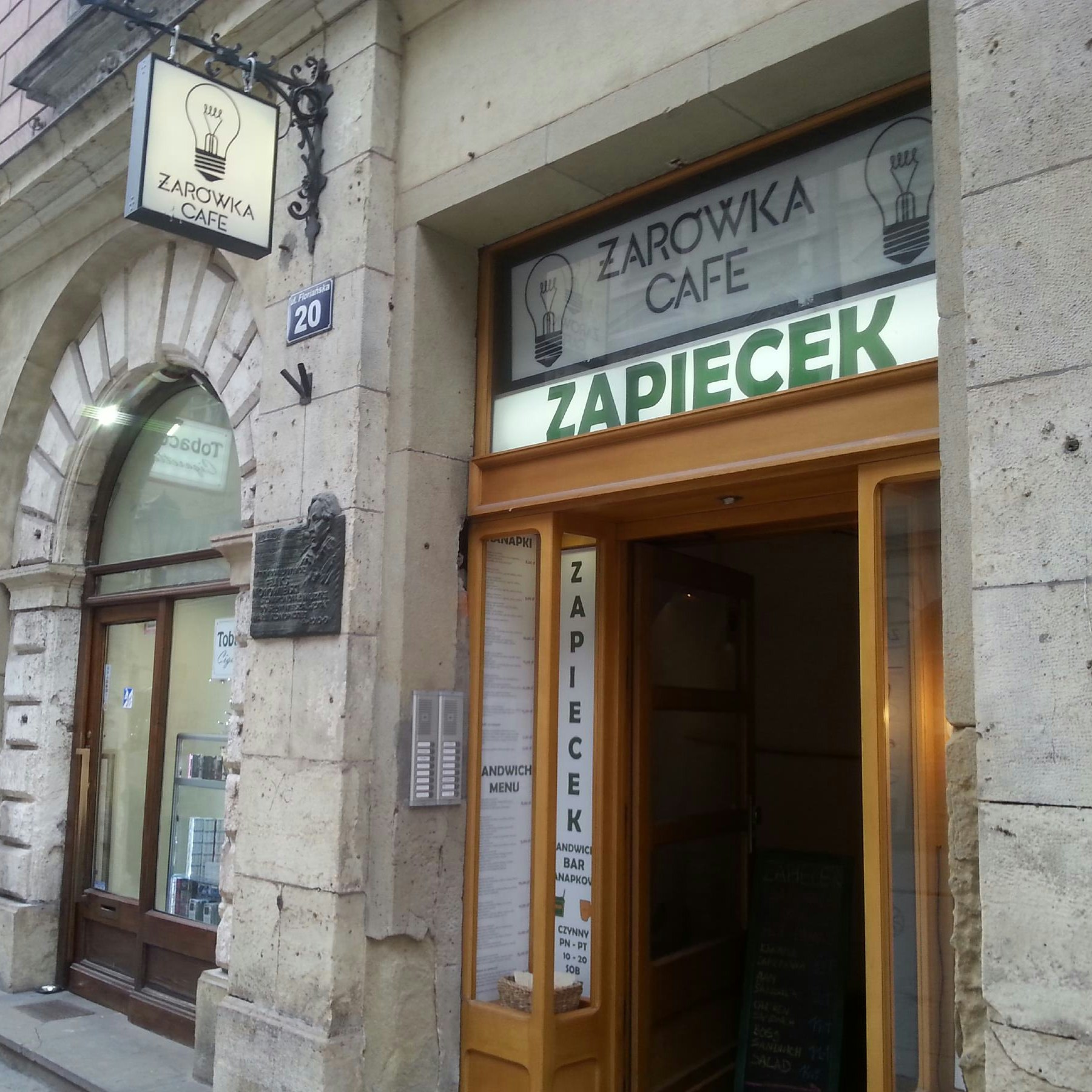 Cafe alleyway is subtley signposted along Florianska