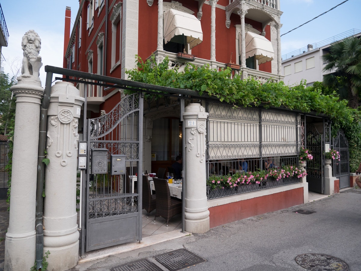 Trattoria Andri stands on a quiet street and has a leafy veranda containing outdoor seating