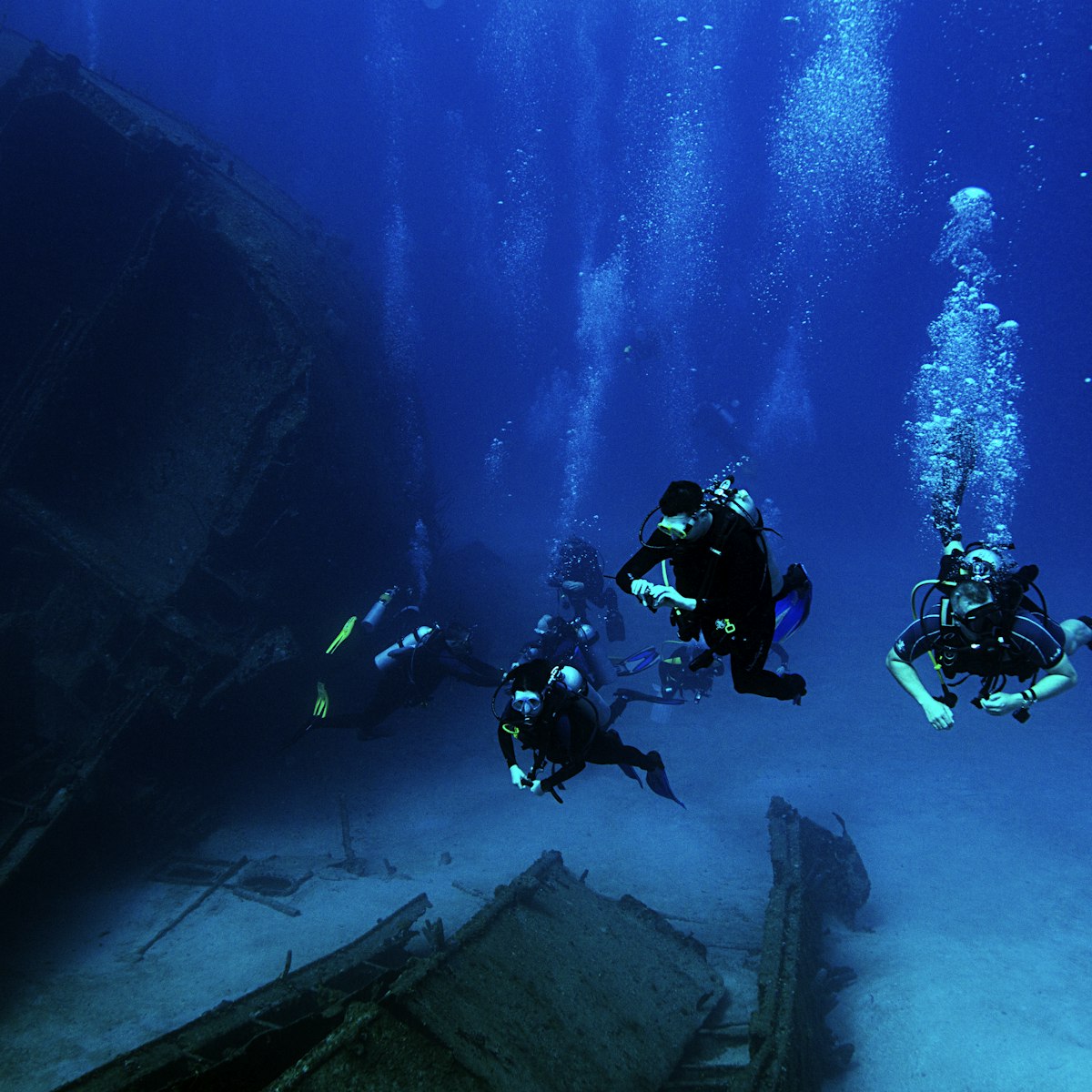Scuba divers explore the El Aguila shipwreck in Roatan, Honduras. The ship sank in 110 feet of water in 1997.