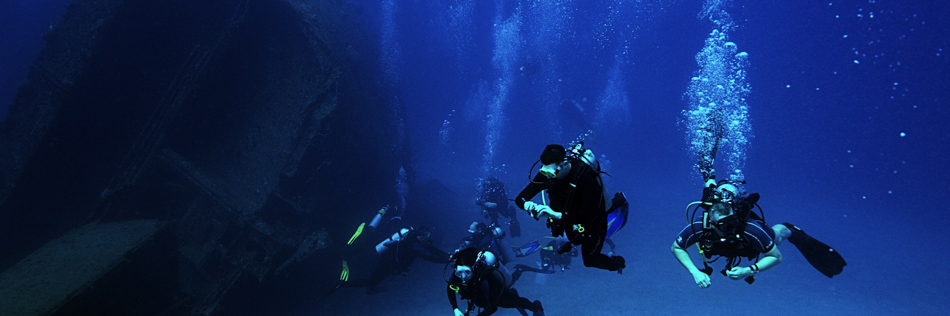 Scuba divers explore the El Aguila shipwreck in Roatan, Honduras. The ship sank in 110 feet of water in 1997.