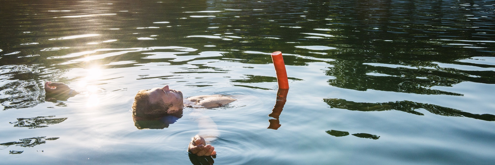 Man floating in thermal Lake Heviz.