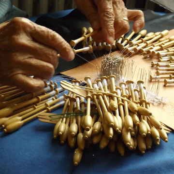 Lace making in Bruges, 2014. The intricate lace patterns in Belgium are unmatched in any other country. The lace trade rose during the early Renaissance. Emperor Charles V decreed that lace-making should be a compulsory skill for girls in convents and beguines throughout Flanders. Lace became fashionable on collars and cuffs for both sexes. Trade reached a peak in the 18th century. Lace makers are traditionally women. Hundreds of craftswomen still work in Bruges and Brussels, centres of bobbin lace, creating intricate work by hand, often using over 100 threads per bobbin. (Photo by: Universal History Archive/UIG via Getty Images)