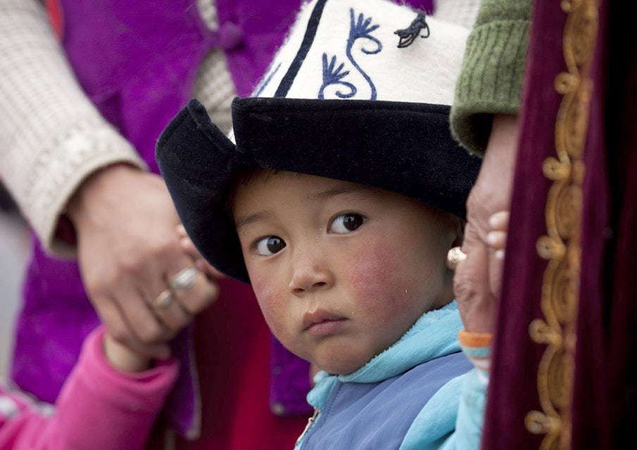 Young boy wearing traditional kalpak felt hat.