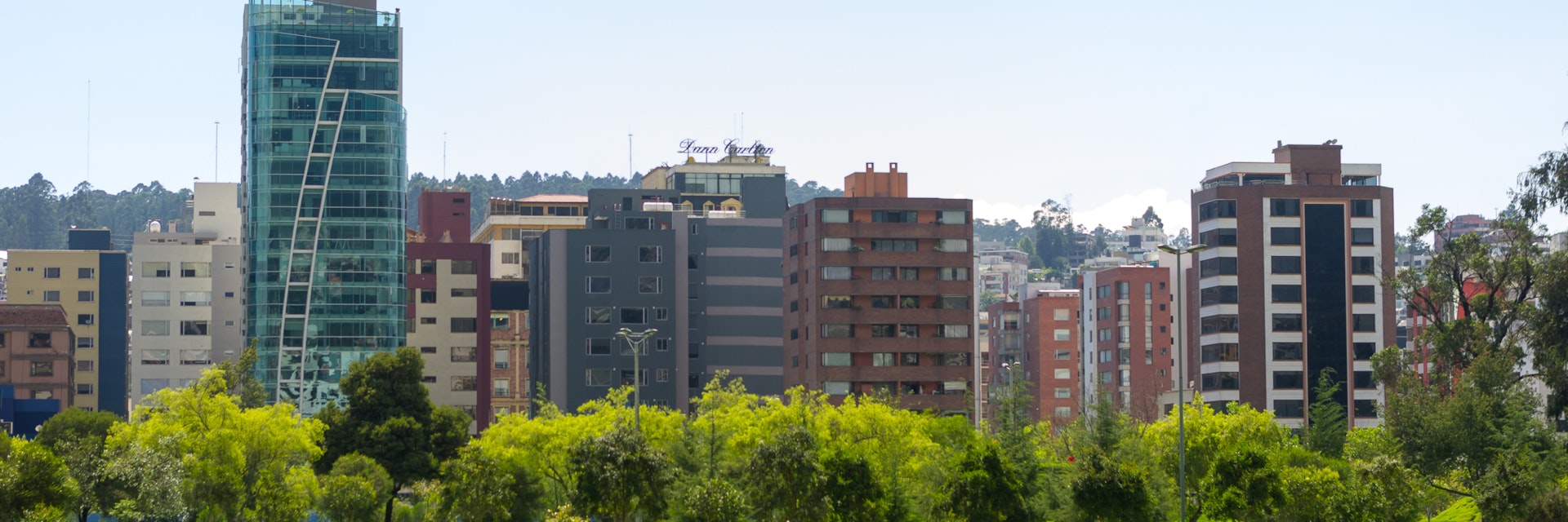 QUITO, ECUADOR- MARCH 20, 2015: Inside La Carolina park in Quito, Ecuador. Beautiful green outdoors with some tall office buildings marking the city presence.; Shutterstock ID 320378906; Your name (First / Last): Josh Vogel; GL account no.: 56530; Netsuite department name: Online Design; Full Product or Project name including edition: Digital Content/Sights