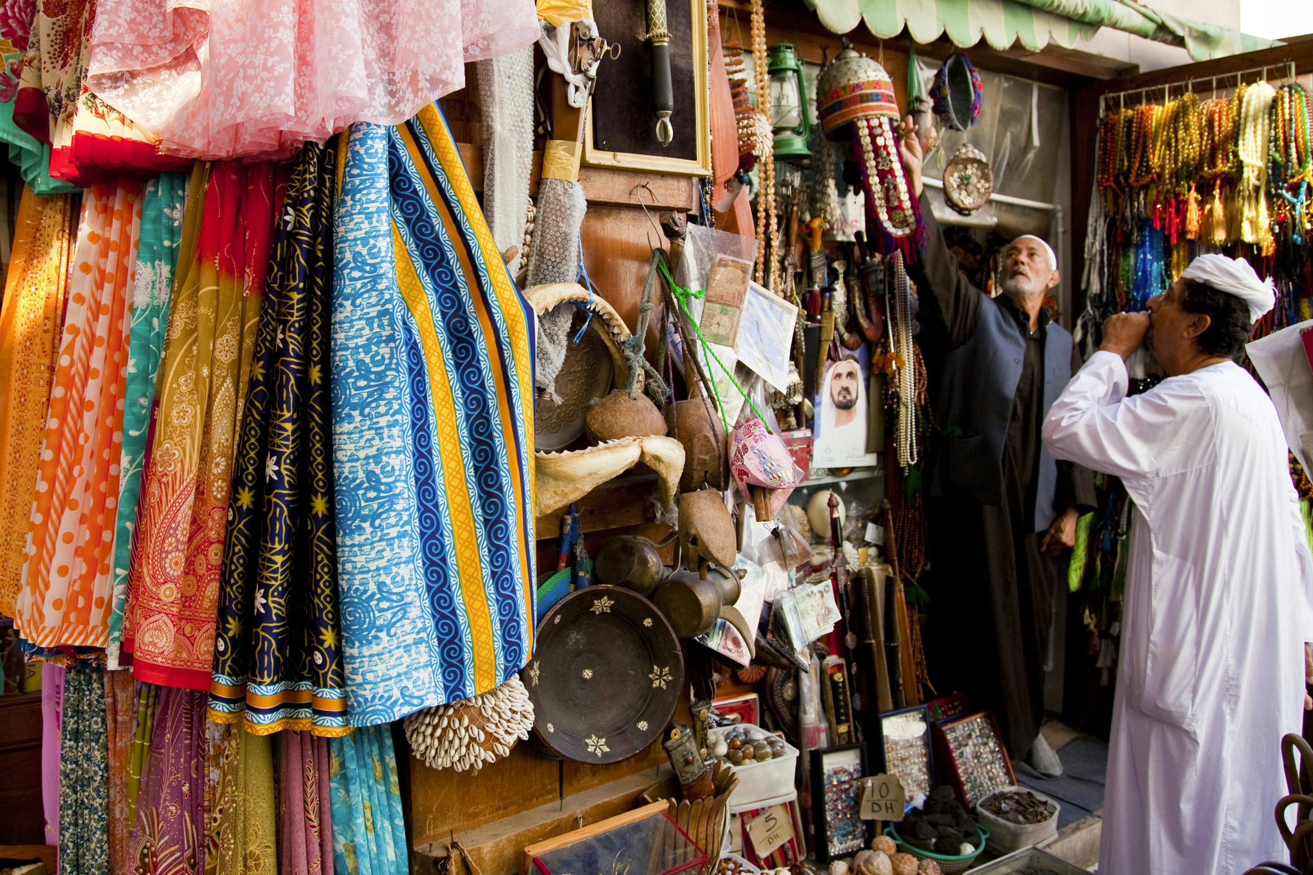 Tourist shopping for souvenirs at Bur Dubai Souq.
