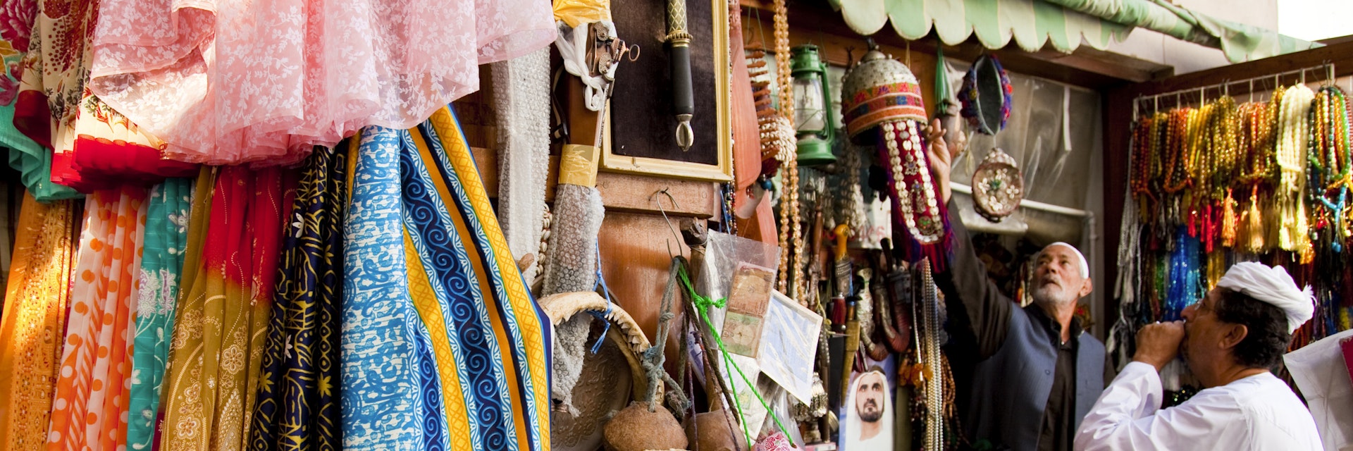 Tourist shopping for souvenirs at Bur Dubai Souq.