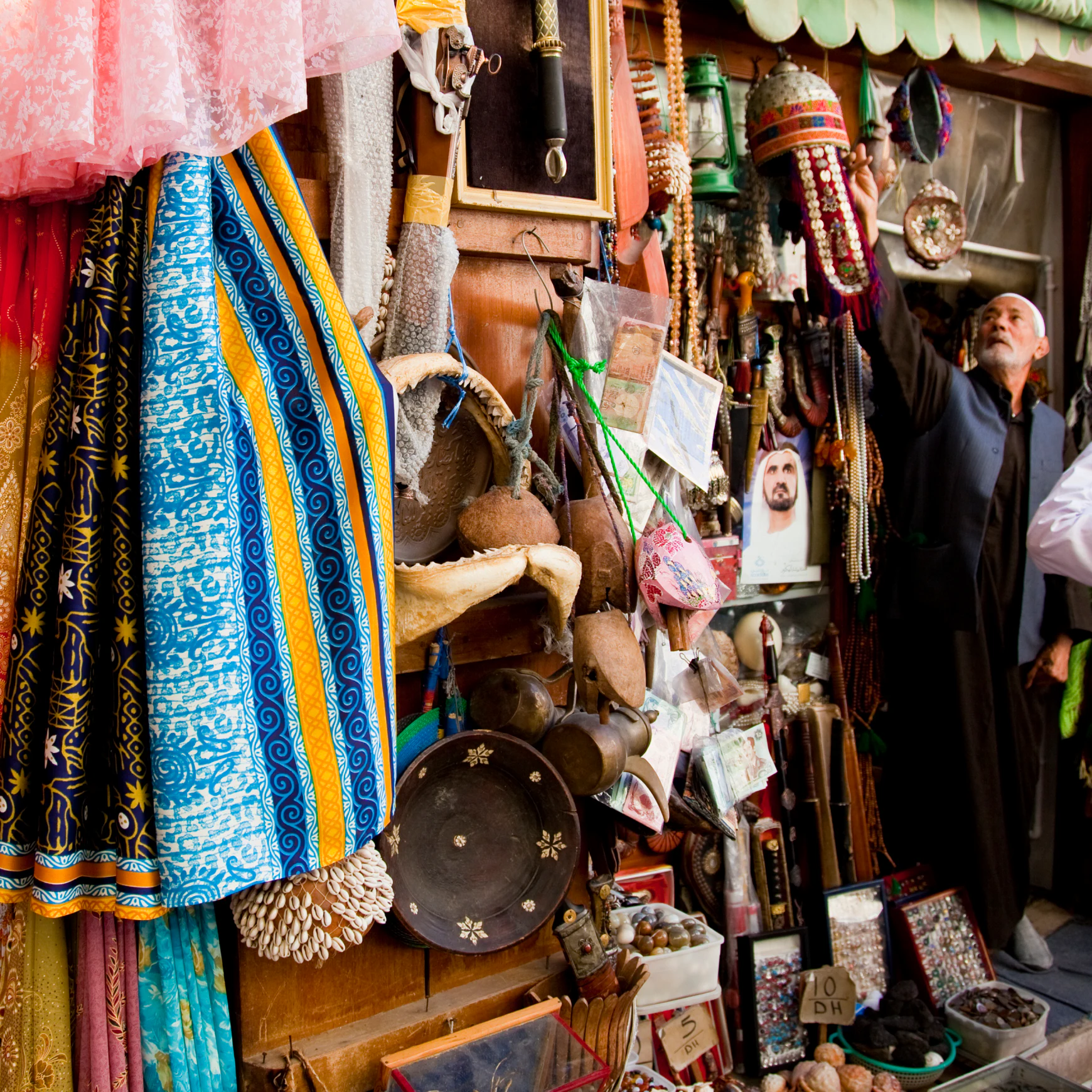 Tourist shopping for souvenirs at Bur Dubai Souq.
