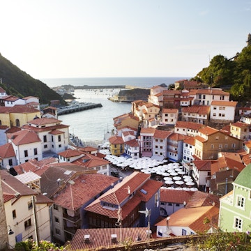 Overview of terracotta roofed houses at port.