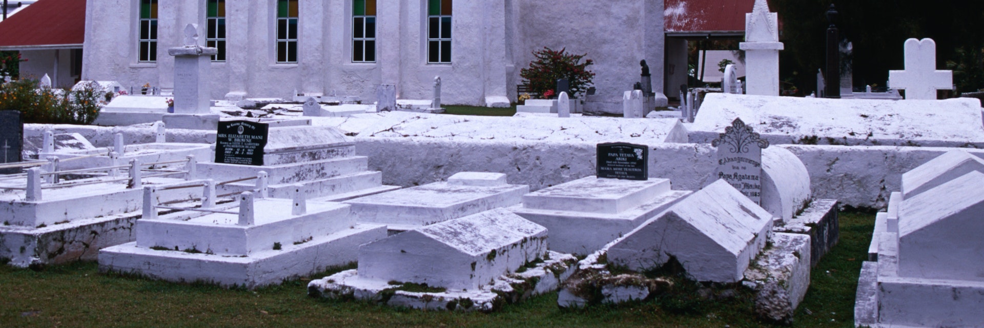 One of many white Christian churches and graveyards on the island of Rarotonga.