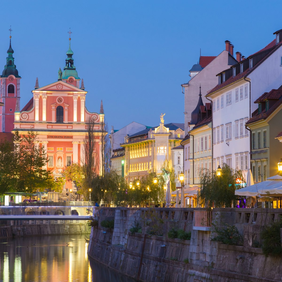 500px Photo ID: 144389993 - Romantic medieval Ljubljana's city center, capital of Slovenia, Europe. Night life on the banks of river Ljubljanica where many bars and restaurants take place. Franciscan Church in background