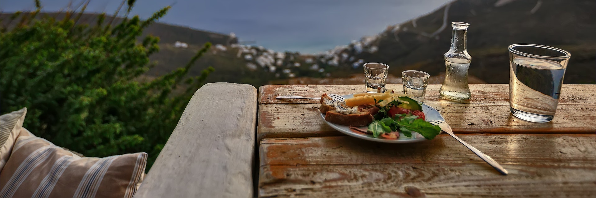 A tsipouro drink with meze and great view to the Aegean, in Tinos island, Greece