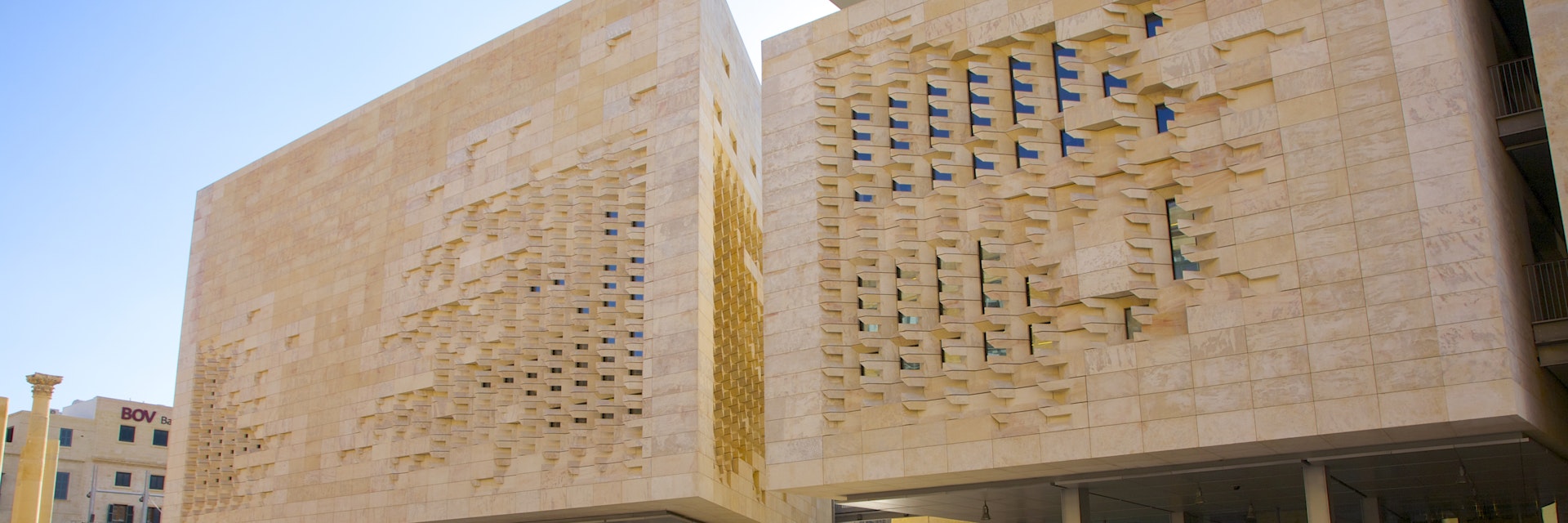 Modern stone and glass Parliament building near Valletta City Gate at entrance to Valletta, Malta.  Designed by architect Renzo Piano of Renzo Piano Building Workshop and completed in 2014.
