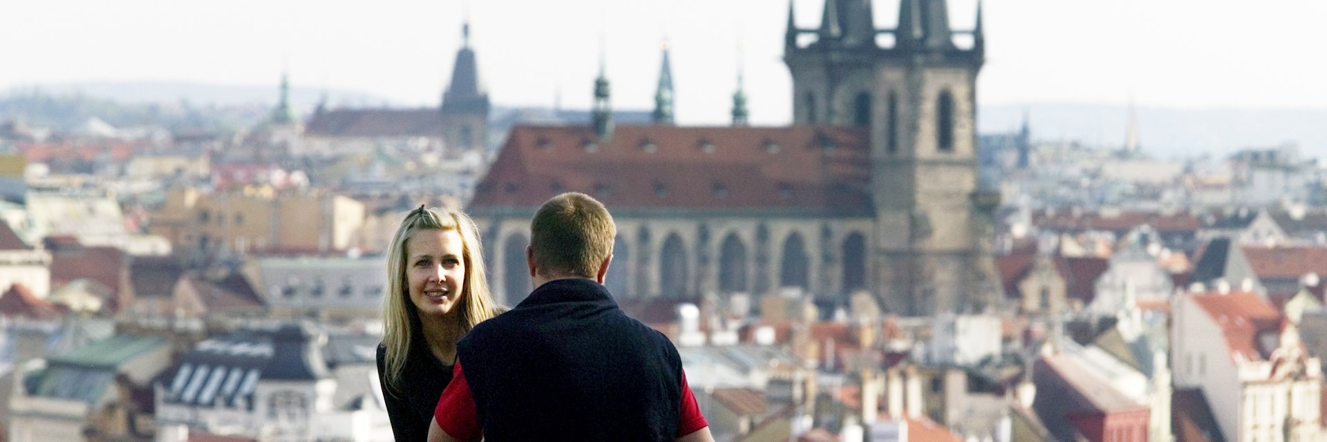 Couple looking over city from Letna Park.