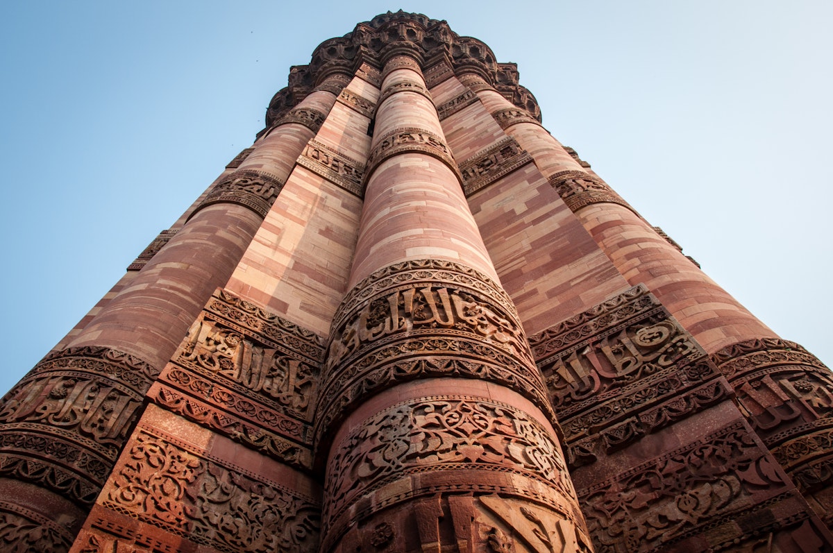 This is a photo of Qutub Minar, showing the intricate engraving and carvings done. The photo instills a sense of strength and poise.