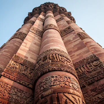 This is a photo of Qutub Minar, showing the intricate engraving and carvings done. The photo instills a sense of strength and poise.