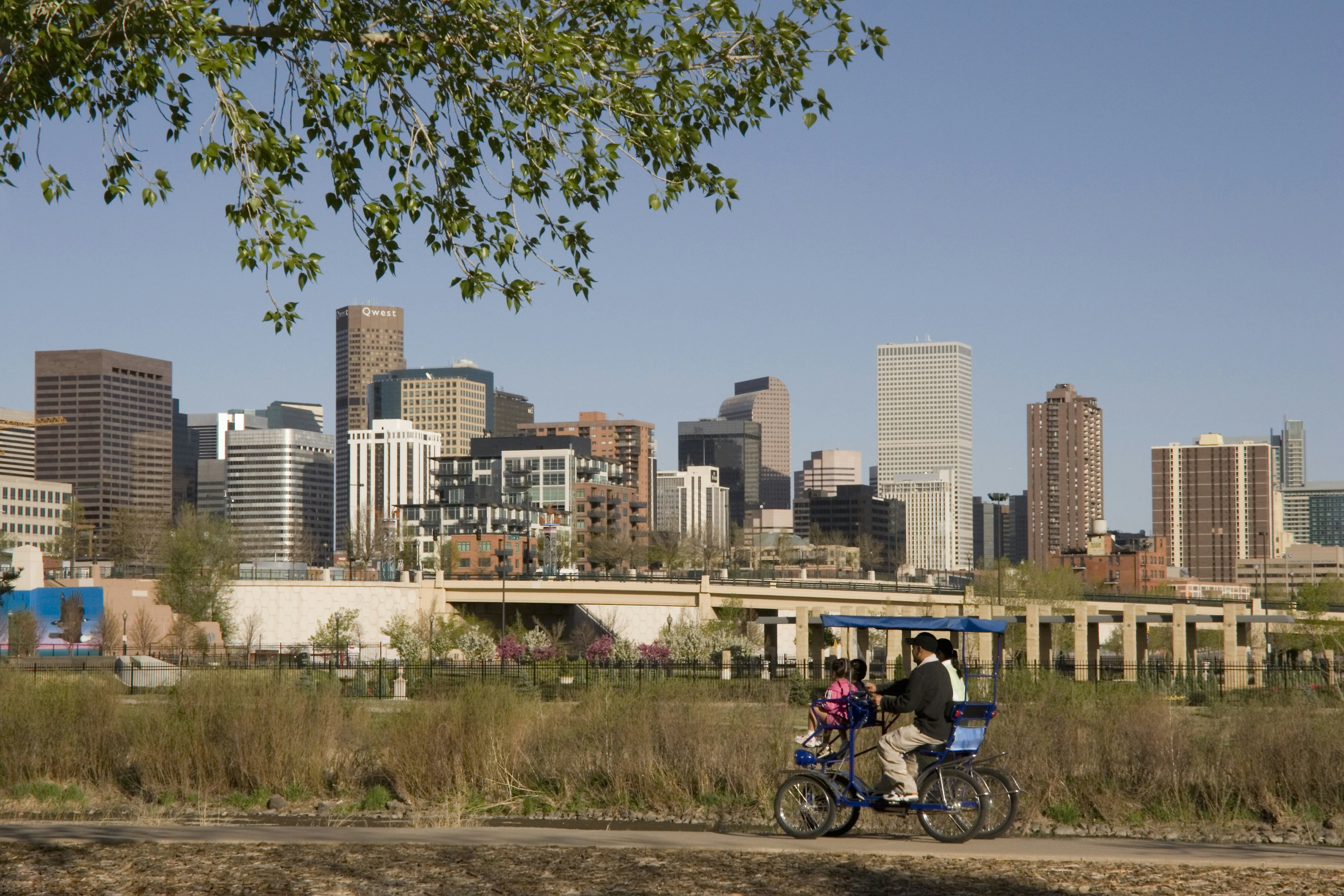 Hispanic family biking in Confluence Park near downtown Denver, Colorado, USA