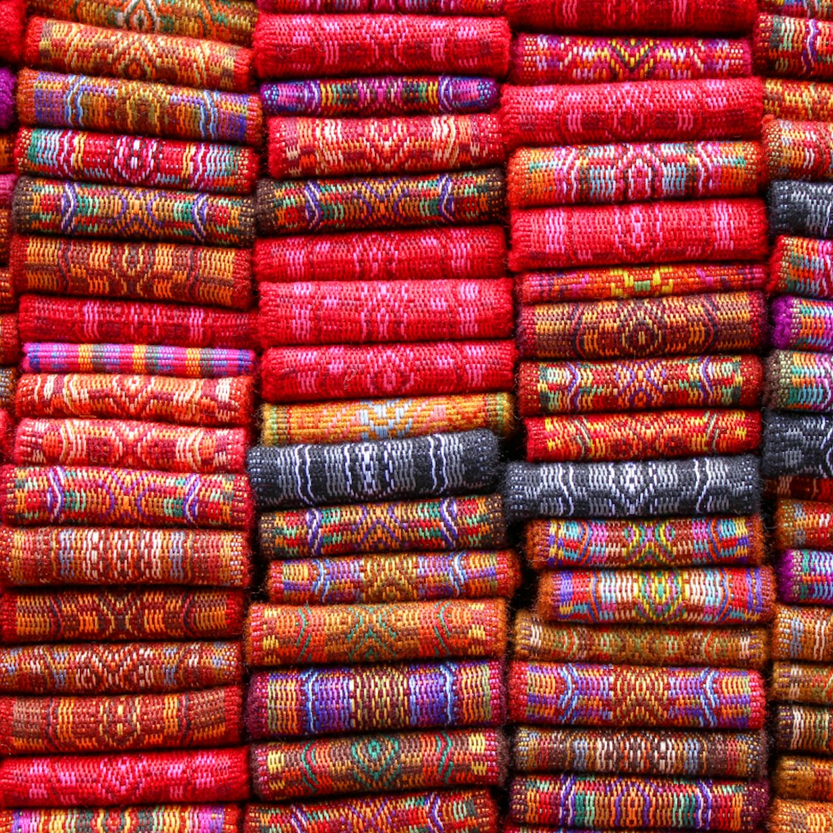 500px Photo ID: 143362997 - Handmade woven sashes for sale at the outdoor craft market in Otavalo, Ecuador