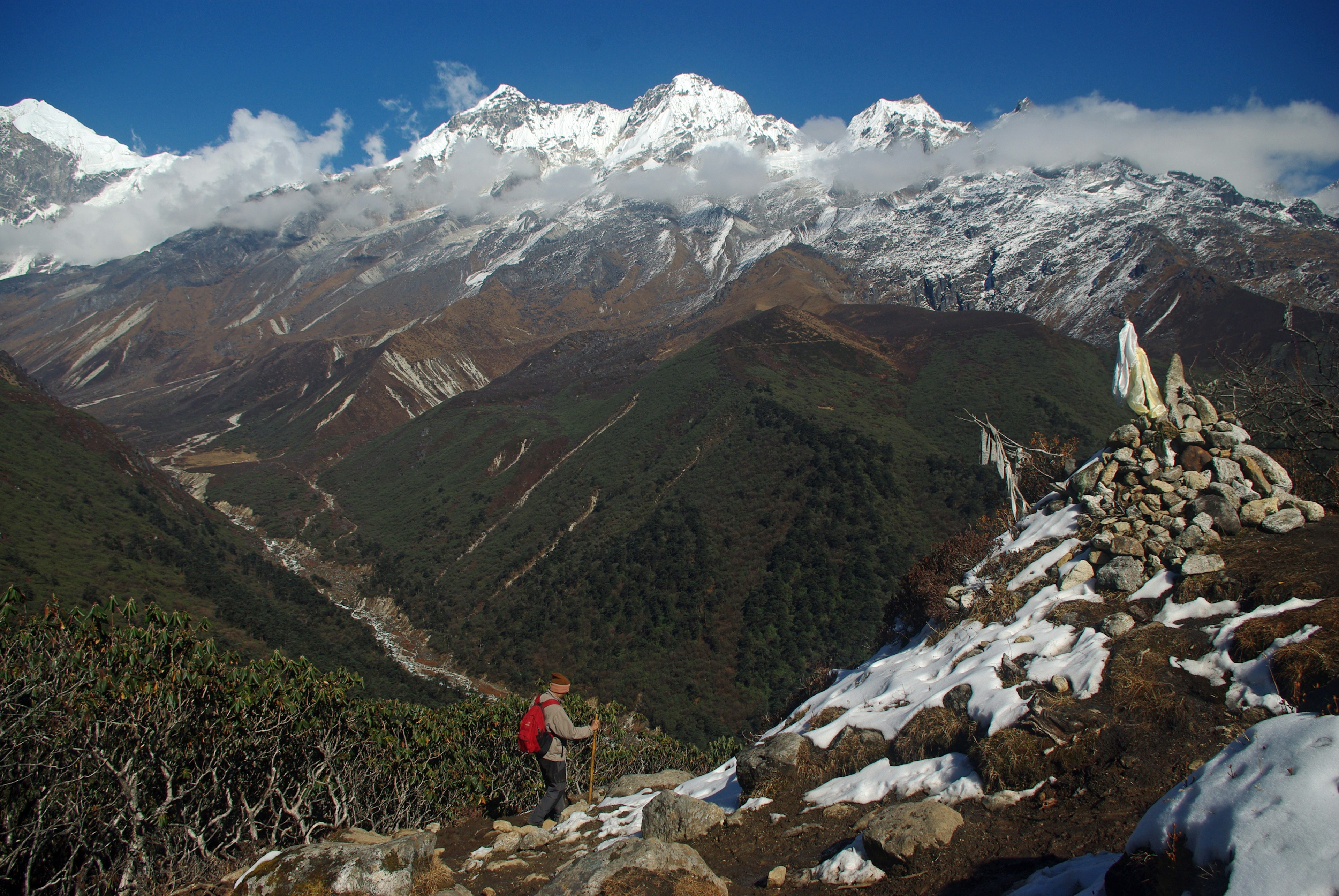 A trekker walking in front of Khangchendzonga in Sikkim