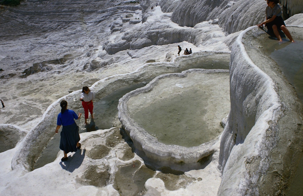 Calcium laden mineral waters cascade over the cliffs of Pamukkale, and as it cools the calcium, it precipitates and clings to the cliffs forming the snow like waterfalls of white stone, however, due to circumstances the site has deteriorated substantially over the years