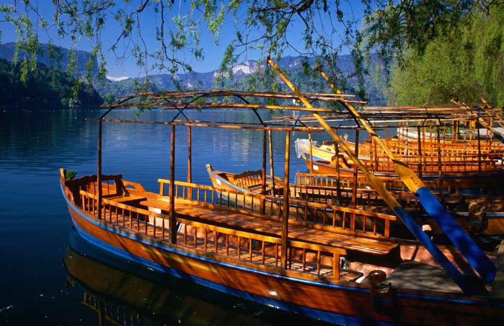 Gondolas, known locally as pletna, on the shores of Lake Bled. These pletna ferry passengers to Bled Island, which sits in the middle of the lake.