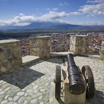 PRIZREN, KOSOVO - APR 10: Cityscape of second biggest city of Kosovo at sunset with red roofed houses and mosques and river in the background a mountain range in Prizren, Kosovo on April 10 2013.; Shutterstock ID 177472613; Your name (First / Last): Brana V; GL account no.: 65050; Netsuite department name: Online Editorial; Full Product or Project name including edition: Kosovo BiE 2018