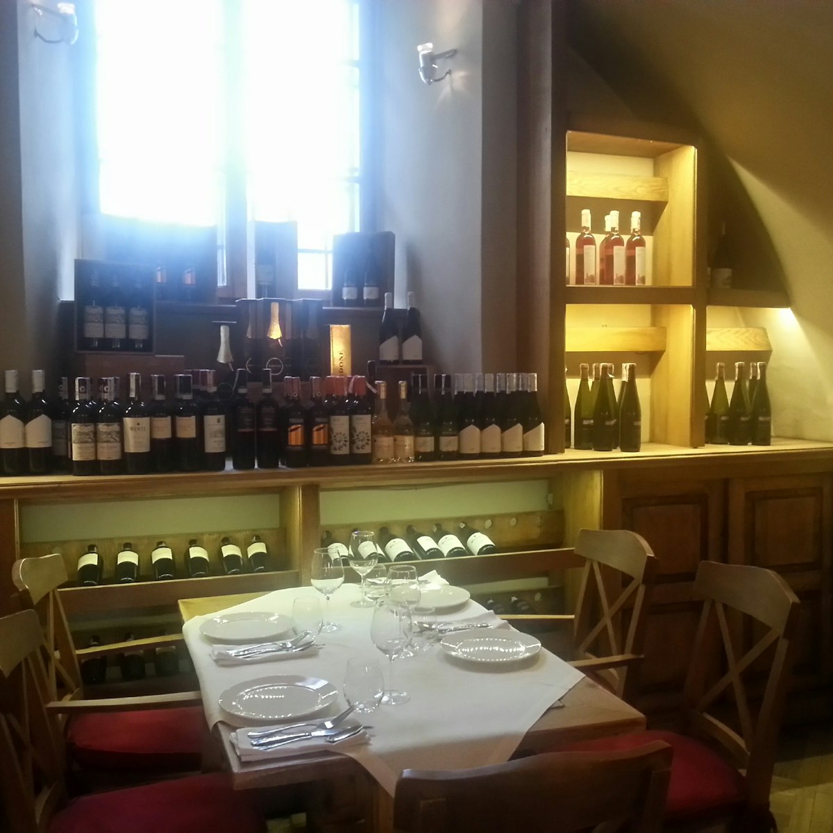 One of La Campana Trattoria's indoor rooms, lined with wine bottles