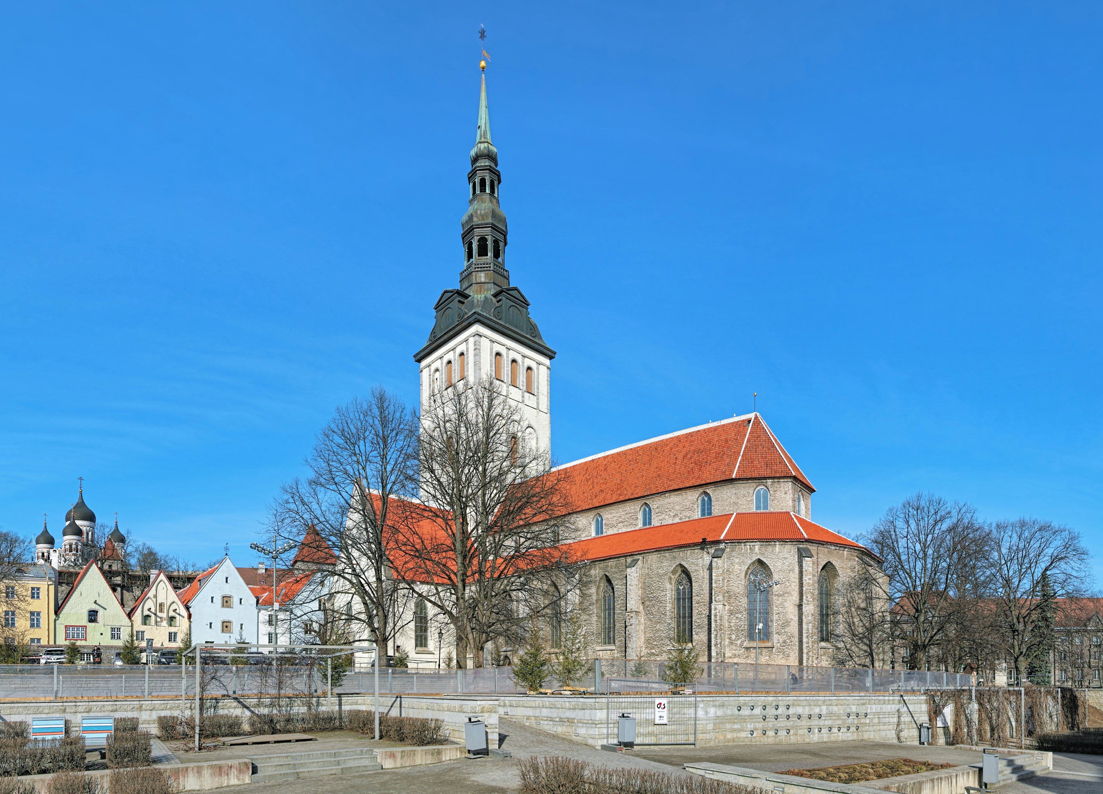 Tallinn, Estonia - March 19, 2015: St. Nicholas Church (Niguliste kirik) and cupola of Alexander Nevsky Cathedral. The St. Nicholas Church was founded and built around 1230-1275. Today it houses a branch of the Art Museum of Estonia.