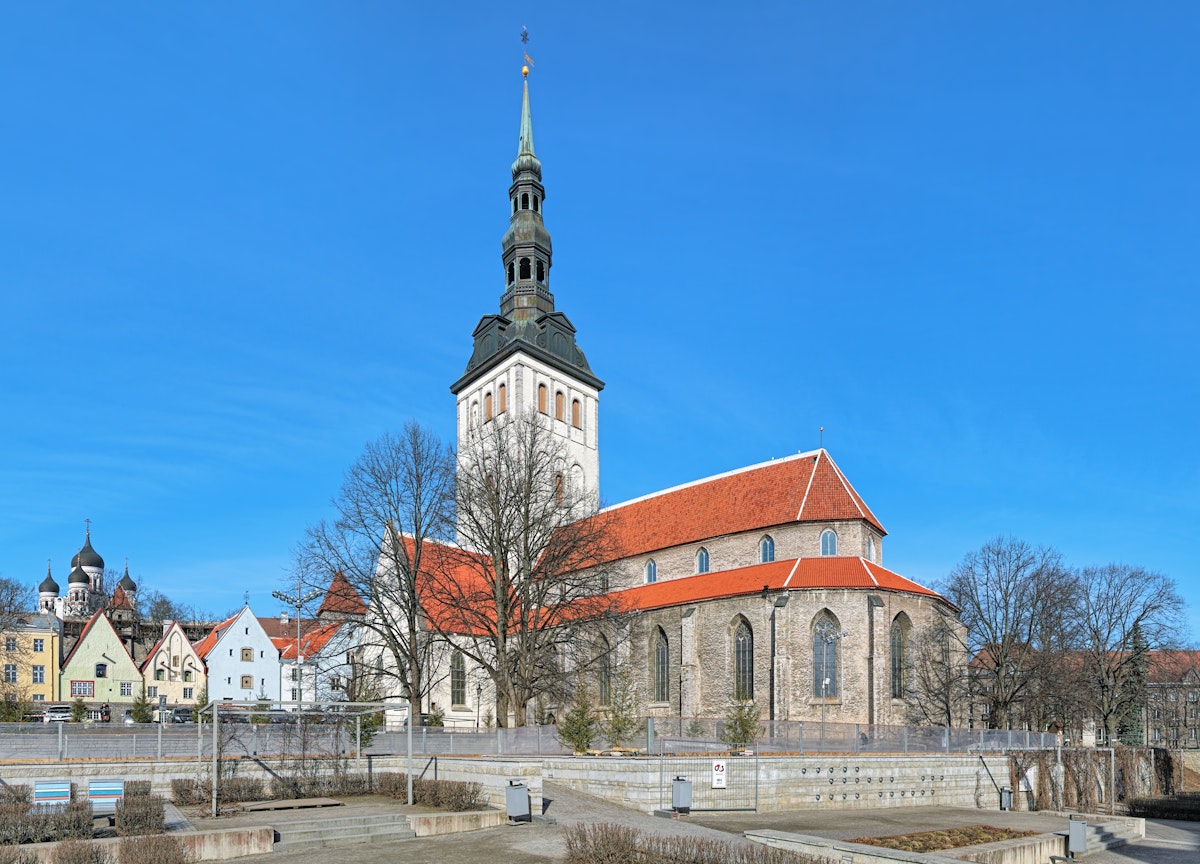 Tallinn, Estonia - March 19, 2015: St. Nicholas Church (Niguliste kirik) and cupola of Alexander Nevsky Cathedral. The St. Nicholas Church was founded and built around 1230-1275. Today it houses a branch of the Art Museum of Estonia.