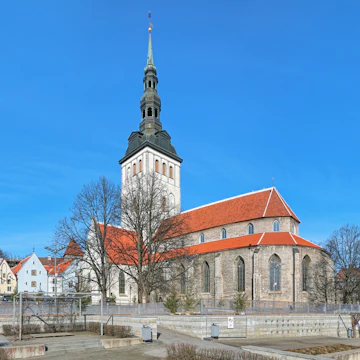 Tallinn, Estonia - March 19, 2015: St. Nicholas Church (Niguliste kirik) and cupola of Alexander Nevsky Cathedral. The St. Nicholas Church was founded and built around 1230-1275. Today it houses a branch of the Art Museum of Estonia.