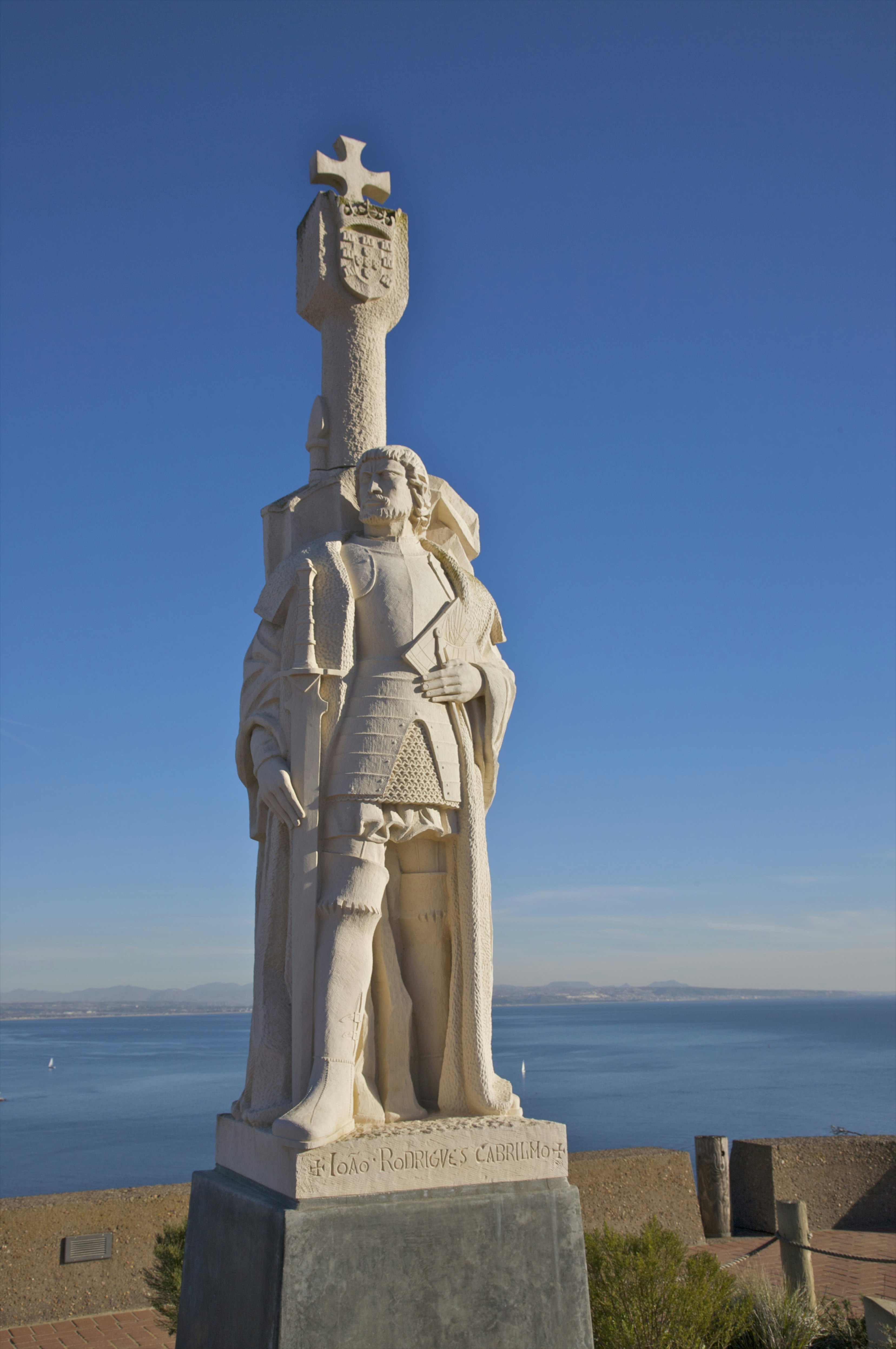 White stone monument near blue ocean and sky