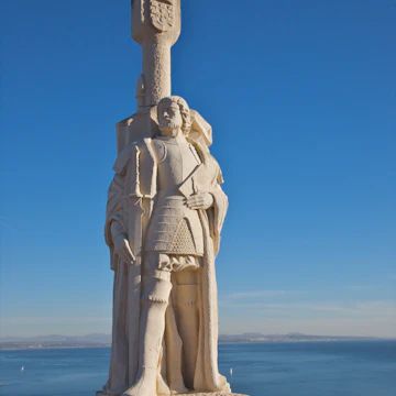 White stone monument near blue ocean and sky
