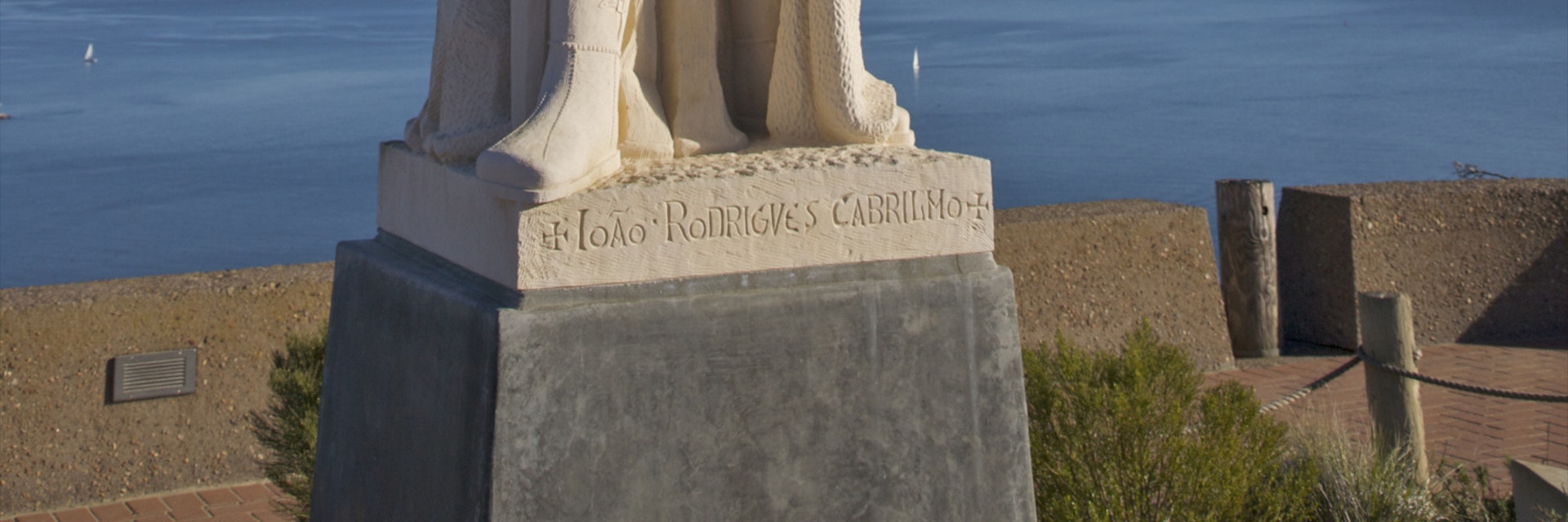 White stone monument near blue ocean and sky