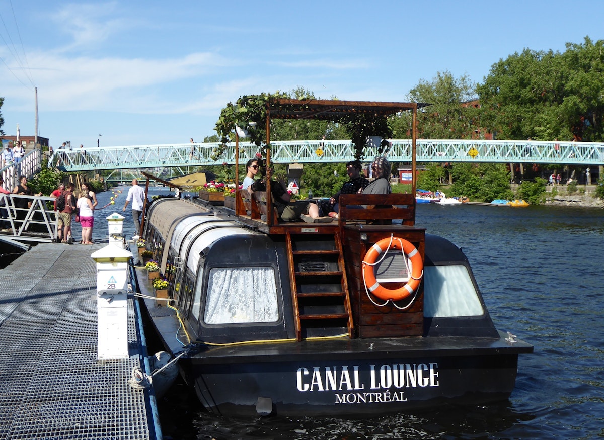 The Canal Lounge is a floating cocktail bar built into a renovated boat parked on the Lachine Canal.