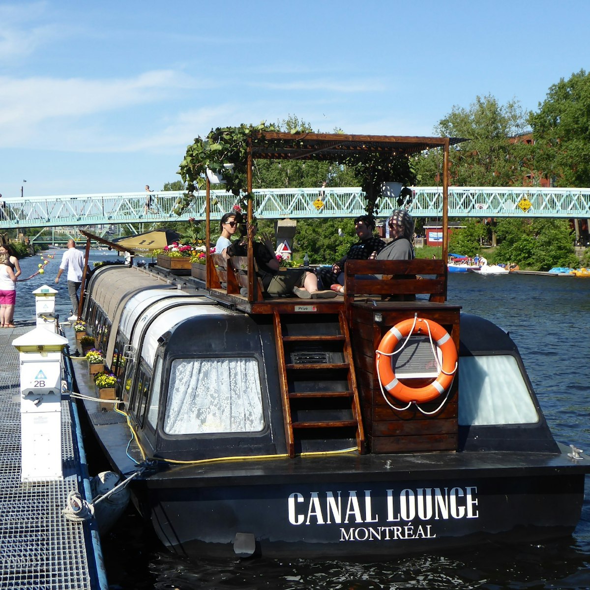 The Canal Lounge is a floating cocktail bar built into a renovated boat parked on the Lachine Canal.
