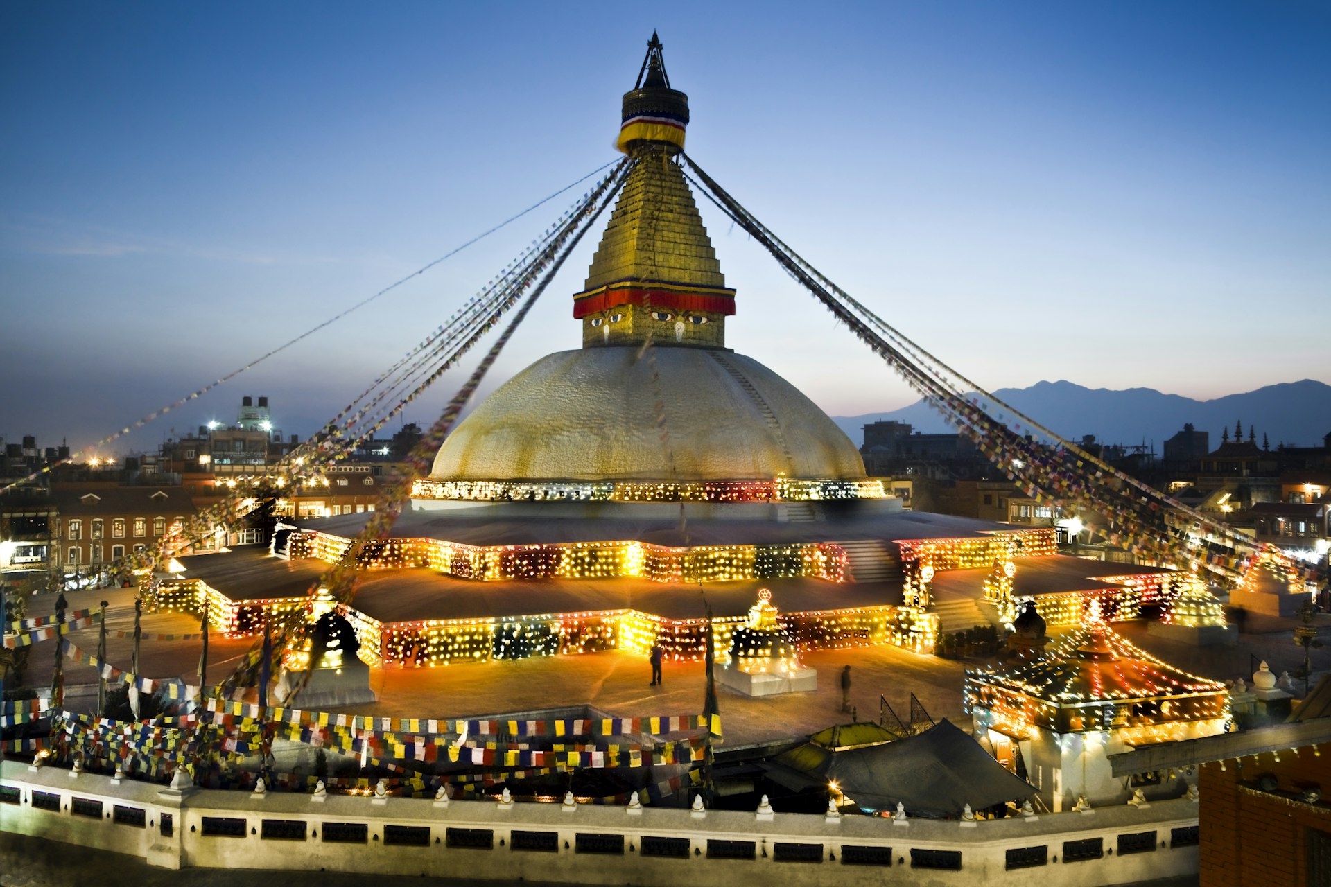 The great stupa at Bodhnath at sunset, lit by many lamps 