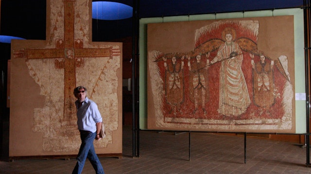 A visitor walks past examples of 10th century Christian art work at the national museum in the capital Khartoum on June 25, 2008. The UN Security Council welcomed yesterday the "Road Map" agreement on the Abyei conflict signed by leaders of north and south Sudan, and called for a UN peacekeeping force to keep a lid on the tension. AFP PHOTO/KHALED DESOUKI (Photo credit should read KHALED DESOUKI/AFP/Getty Images)