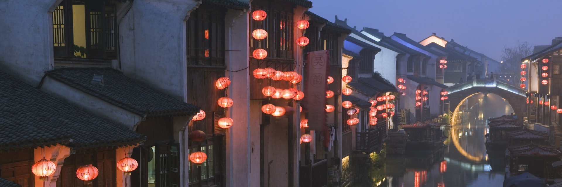 Traditional old riverside houses illuminated at night in Shantang water town, Suzhou, Jiangsu Province, China, Asia