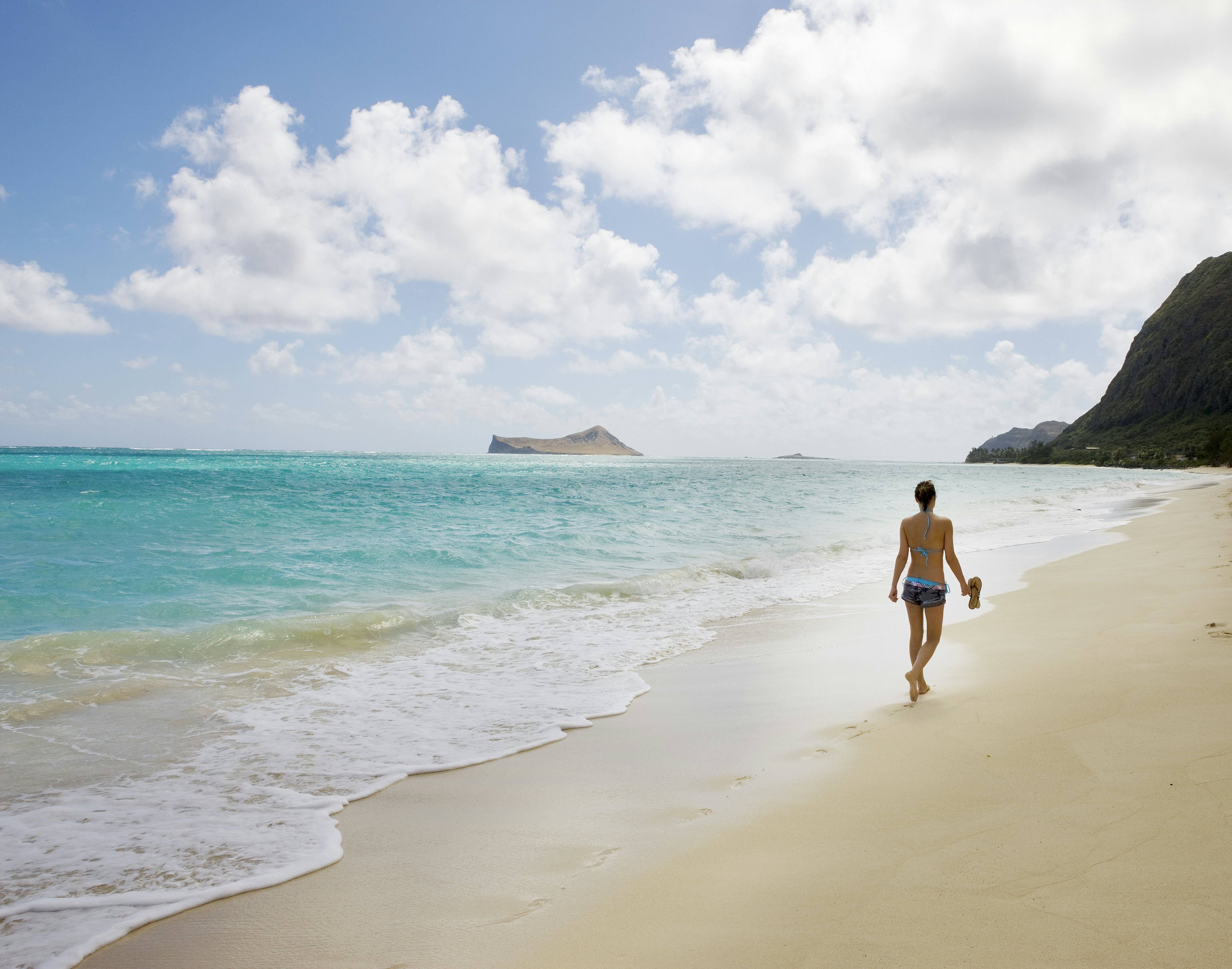 Woman walk on the beach, near view