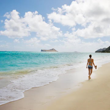 Woman walk on the beach, near view
