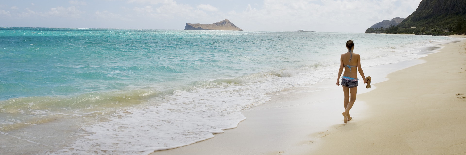 Woman walk on the beach, near view