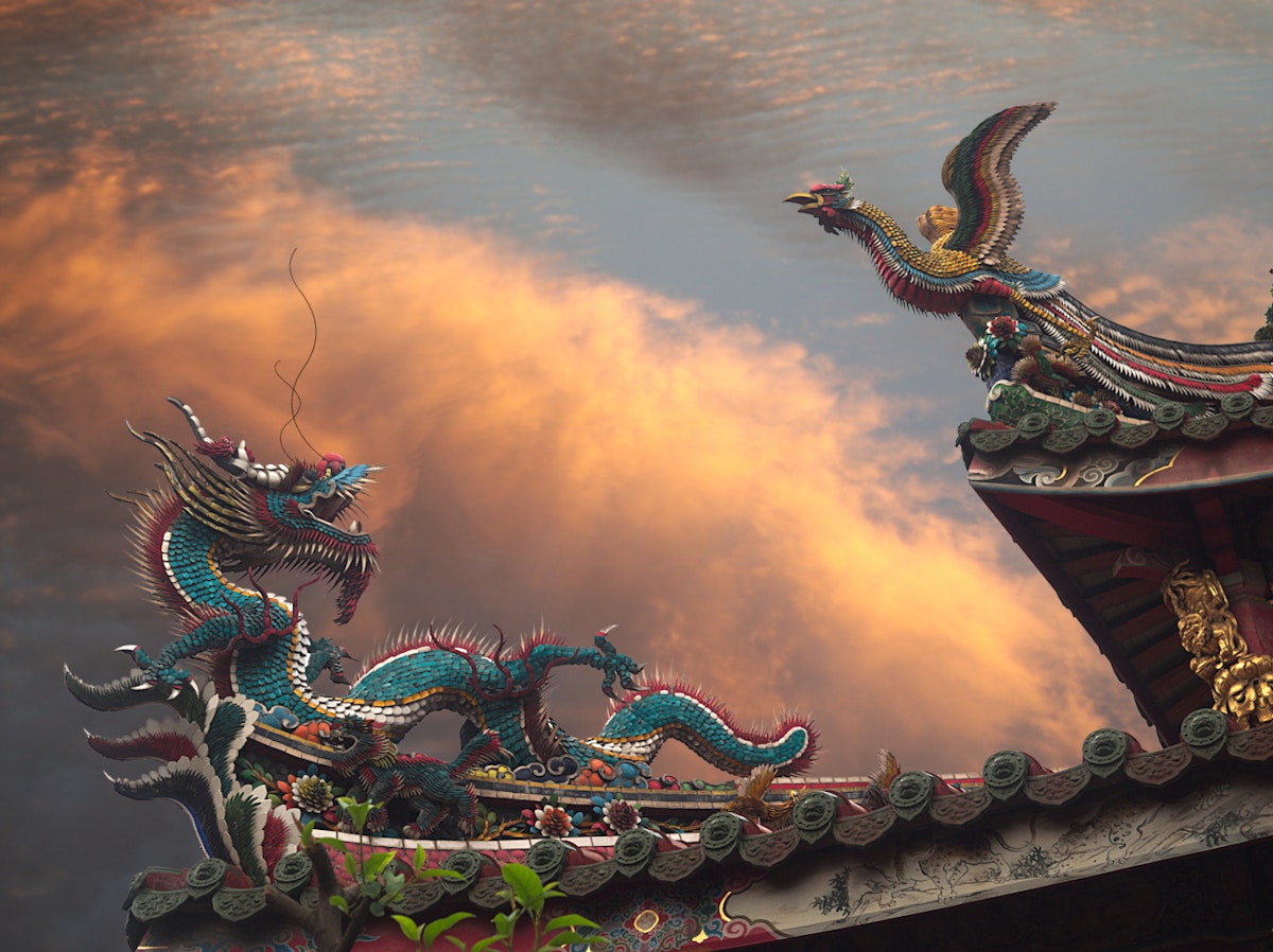 500px Photo ID: 132008549 - A Dragon and a Phoenix (Fenghuang  fènghuáng / 凤凰 / 鳳凰 or August Rooster kūnjī / 鹍鸡 / 鶤雞) on the roof of Mengjia Longshan Temple (艋舺龍山寺 nee Lungshan Temple) in Wanhua District, Taipei, Taiwan. Golden Hour, dramatic clouds in background. Temple is of Chinese folk religion.