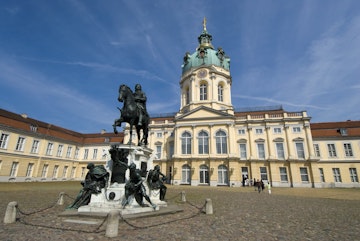 Statue of the Great Elector Frederick William of Brandenburg standing in grand courtyard of Charlottenburg Palace.