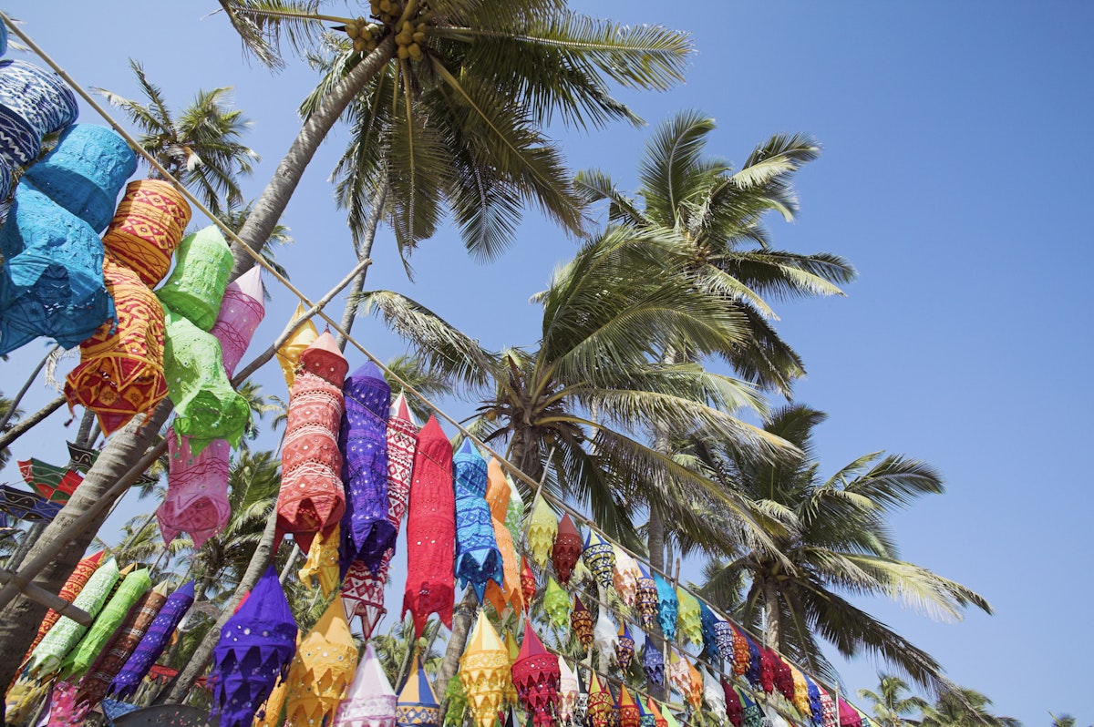 Colorful lamp shades and palm trees at Anjuna Beach flea market