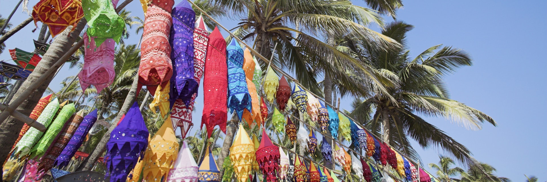 Colorful lamp shades and palm trees at Anjuna Beach flea market
