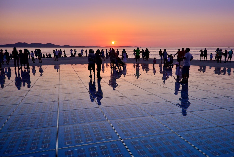Sunset in Zadar...Greetings to the sun is an art installation located in the port of Zadar, on the western point of the Zadar peninsula. It is overlooking the city harbor, islands and famous Zadar sunset...The Greetings to sun uses solar power to create a light show that displays at night. After sunset the lighting elements are activated installed in the circuit, and following a particularly programmed scenario, they produce very impressive show of light.