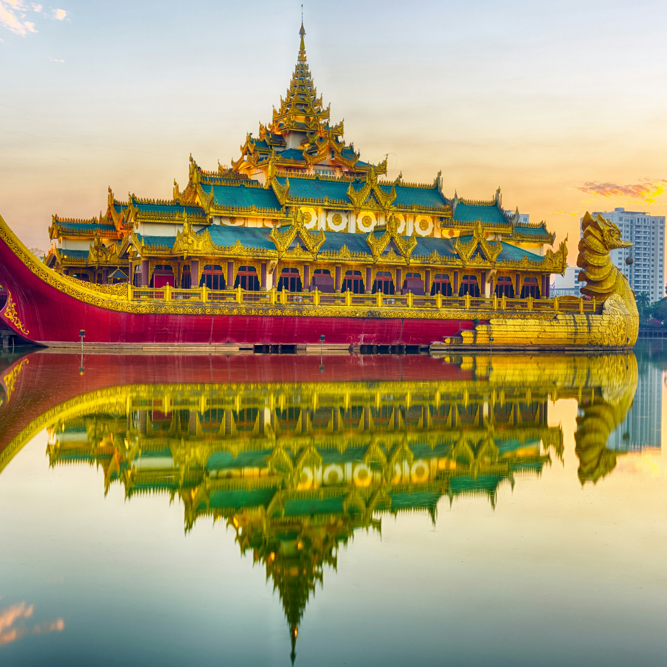 Golden Karaweik palace reflecting on Kandawgyi lake looks like an ancient royal barge. Sunset time. Yangon, Myanmar ; Shutterstock ID 420418678; Your name (First / Last): Laura Crawford; GL account no.: 65050; Netsuite department name: Online Editorial; Full Product or Project name including edition: Yangon images for city app POIs
