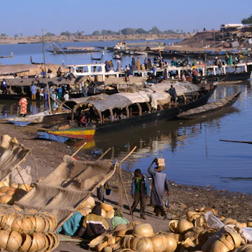 Fully laden Pinasses docked at the jetty with more cargo on the shores of the Niger river, Mopti